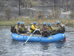 Josh Randall rows firefighters accross the Poudre river.