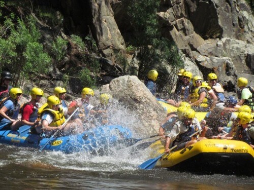 Guests of Mountain Whitewater enjoy a water fight on the Cache la Poudre River